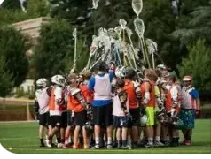 Monarch Boys Lacrosse players gathered around their coaches